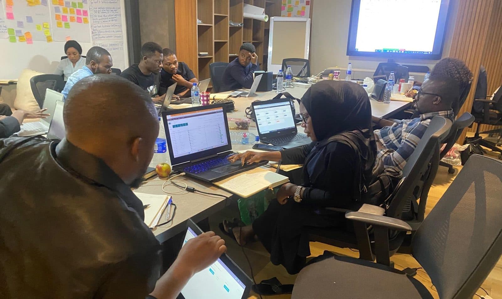 Finance team working on laptops with Odoo during a system changeover